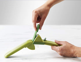 Joseph Joseph CleanForce garlic press curved tip scraping skin from inside the head