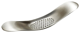 Joseph Joseph Garlic Rocker in action crushing cloves for fast prep.