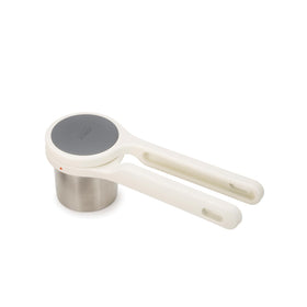 Joseph Joseph Helix potato ricer twist-action in use for smooth mashed potatoes