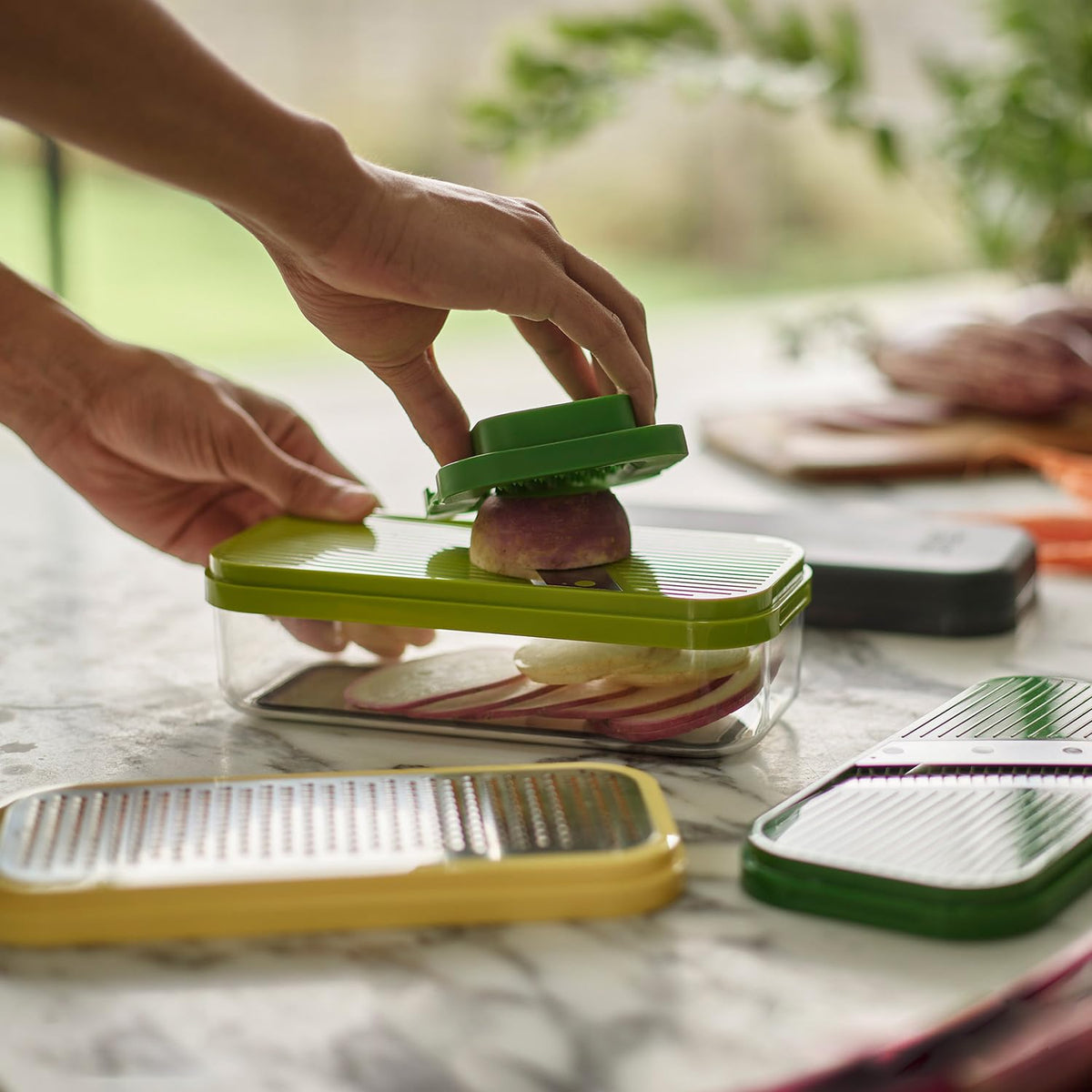 Joseph Joseph Multi-Prep blades close-up show chopper, grater, slicer, julienne options.