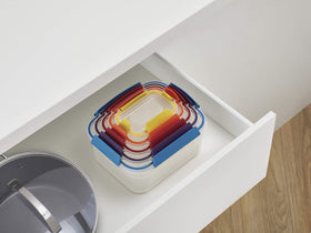 Joseph Joseph Nest Lock lids clipped together for space-saving organization.