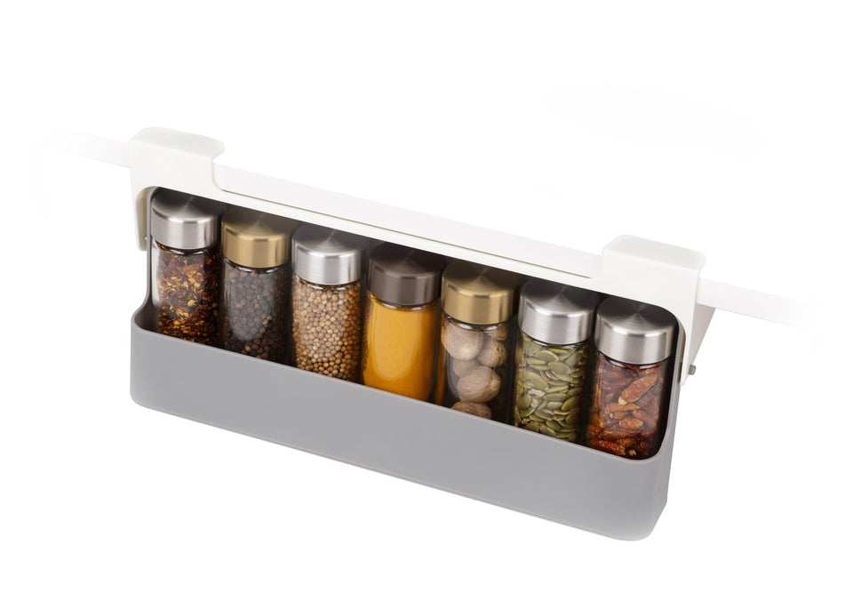 Joseph Joseph spice rack under-shelf organizer shown during installation, increases cabinet storage.