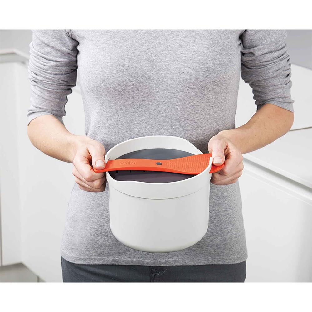 Joseph Joseph M-Cuisine serving spoon doubles as lid-lock for cooking.