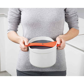 Joseph Joseph M-Cuisine serving spoon doubles as lid-lock for cooking.
