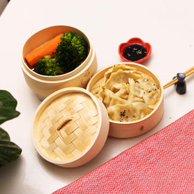 Joyce Chen bamboo steamer over a wok for steaming fish and delicate proteins.