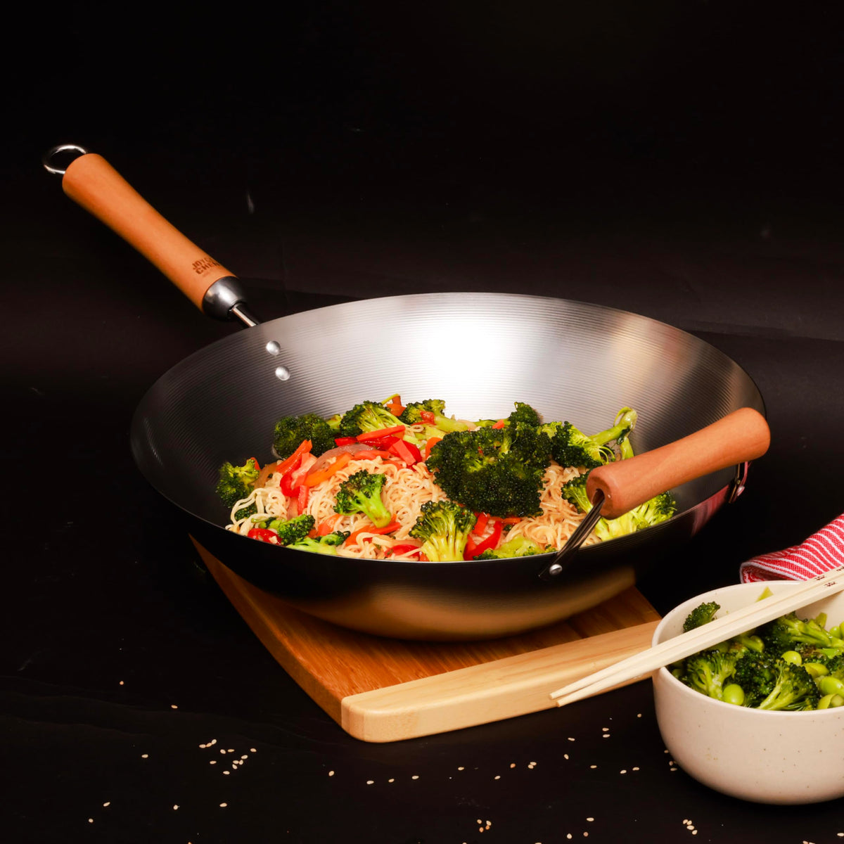 Joyce Chen birch handles close-up, ergonomic grip for tossing vegetables.