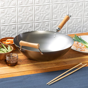 Joyce Chen carbon steel wok being hand-washed, quick-drying care tips.
