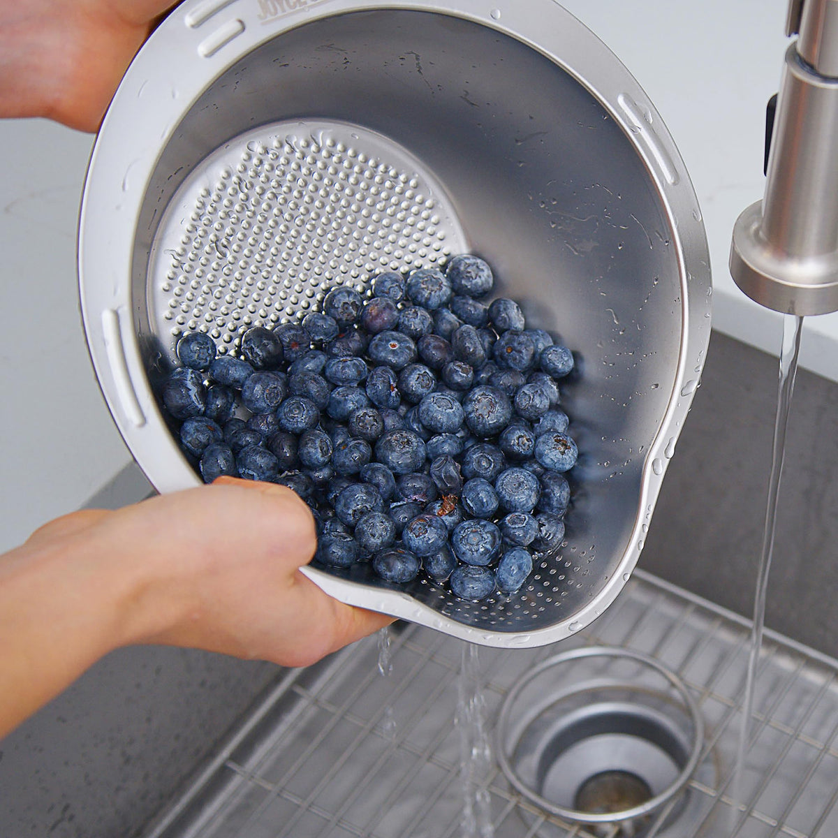 Joyce Chen rice washer bowl drain angled bottom demonstrates quick drainage during washing.