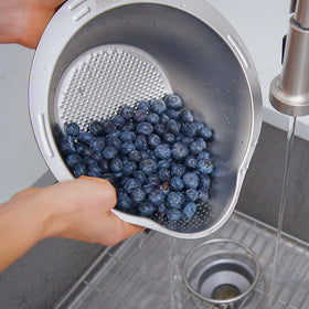 Joyce Chen rice washer bowl drain angled bottom demonstrates quick drainage during washing.