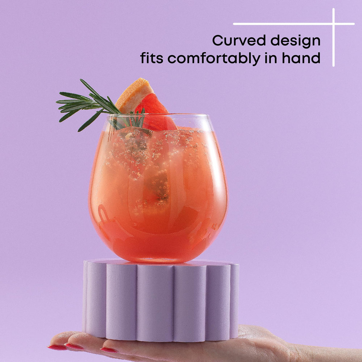 Close-up of JoyJolt Spirits stemless design fitting comfortably in hand