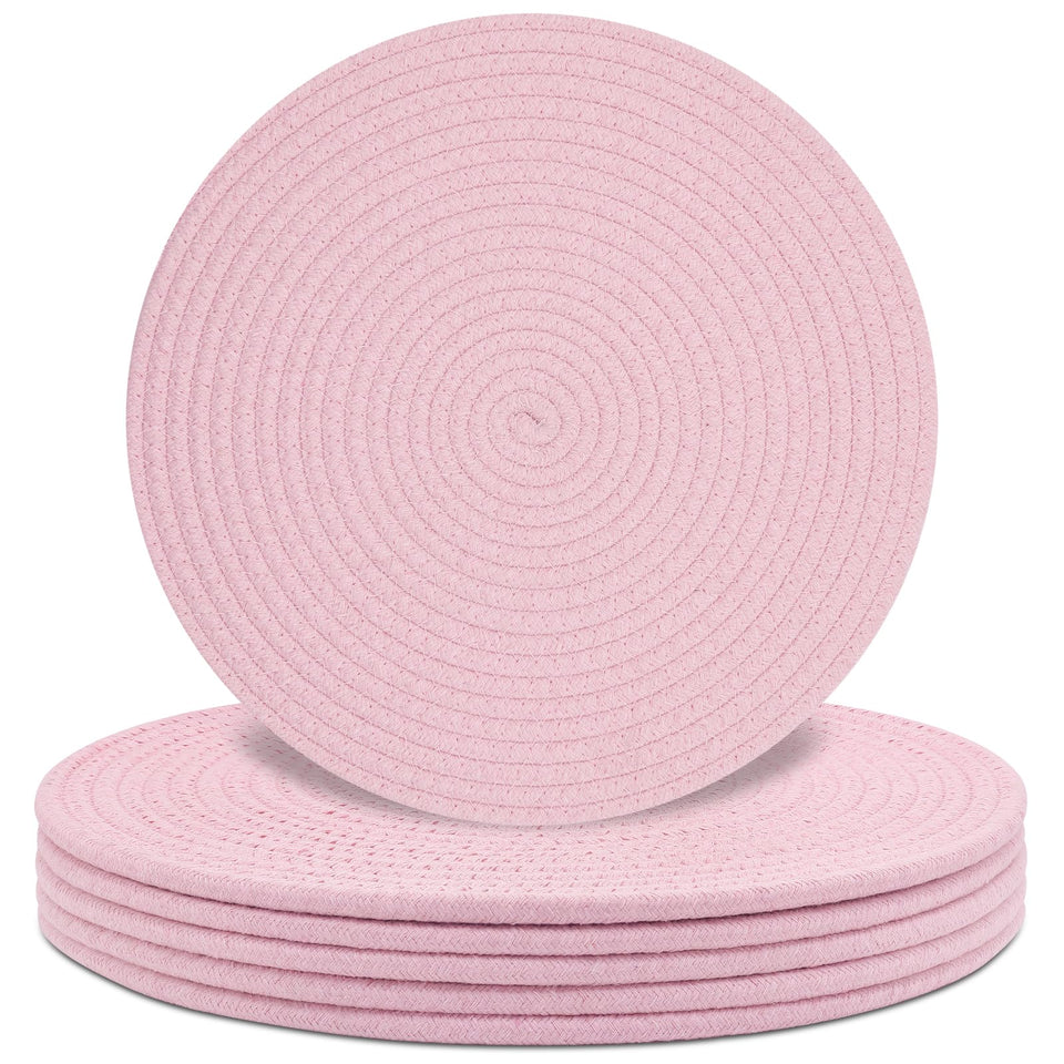 Jukercici round pink placemats with woven texture protect surfaces during meals.