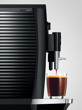 Jura E4 espresso pouring into a cup, capturing barista-quality crema at home.