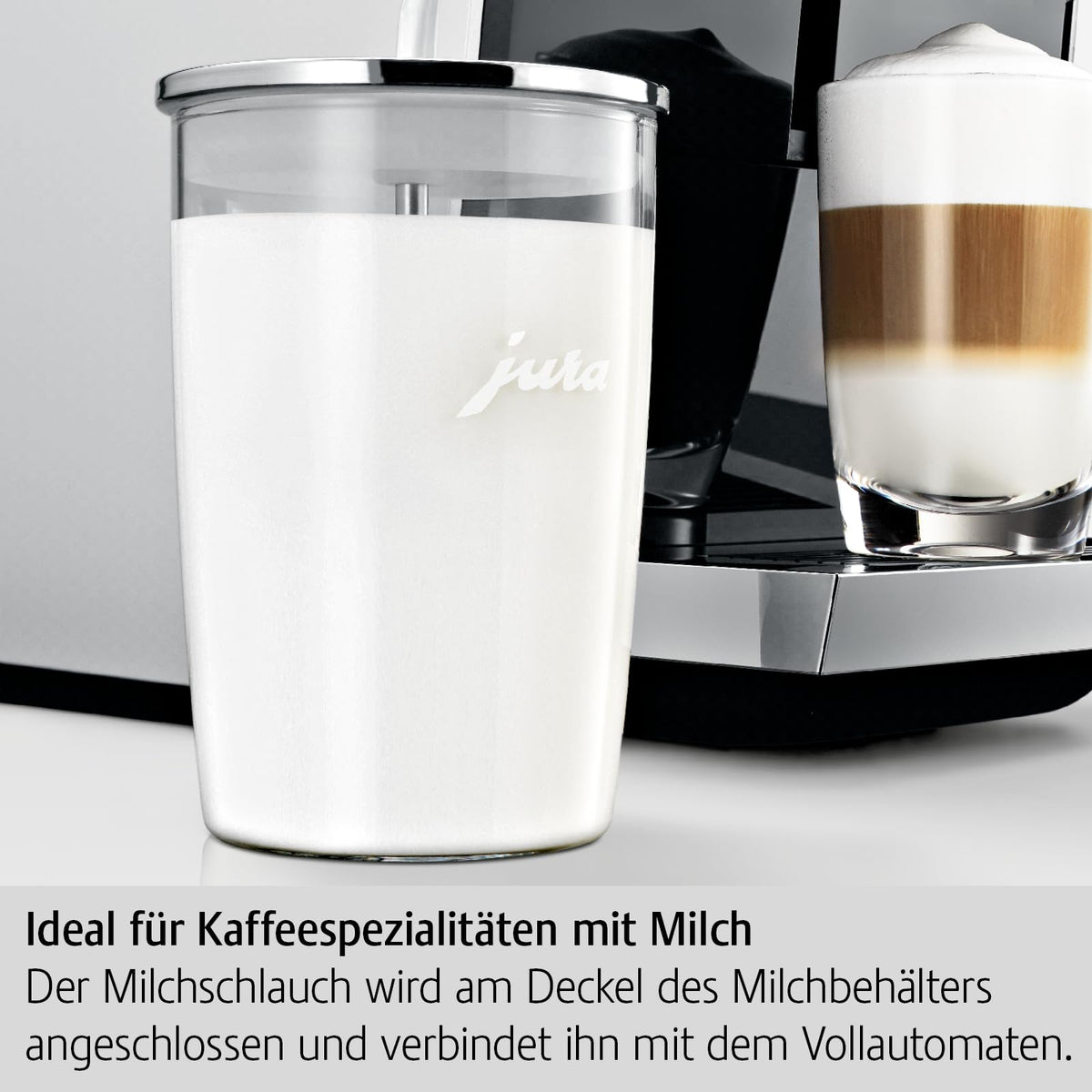 Jura glass milk container attached to coffee machine for convenient use.