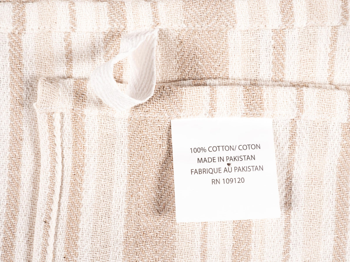 KAF Home beige flat kitchen towels on a towel rack.