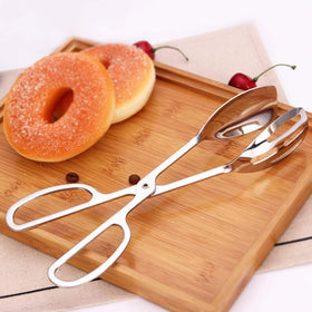 KEBE 2-Pack serving tongs lifting cake slice, mirror finish enhances presentation.