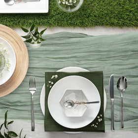 Keepshowing Christmas dinner table setup with gauze runner for festive charm.