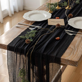 Keketoarrange black table runner with cheesecloth drape, ideal for elegant weddings.