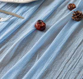 Keketoarrange boho table decor with light blue gauze runner on a long table.