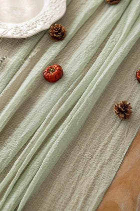 Keketoarrange sage green runner at a wedding table with soft drape