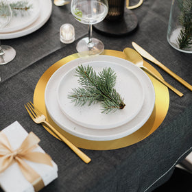 KesaPlan mirrored gold charger placemats guard against spills while elevating the setting.