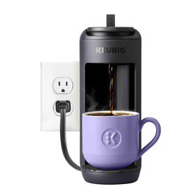 K-Mini Mate with a travel mug ready on a compact counter.