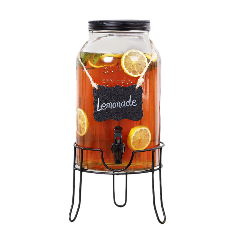 Khlotiko 1.5-gallon glass dispenser with stand on a party table for an elegant beverage station.