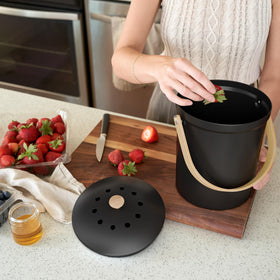 KIBAGA wooden handle aids easy transport from counter to trash or compost.