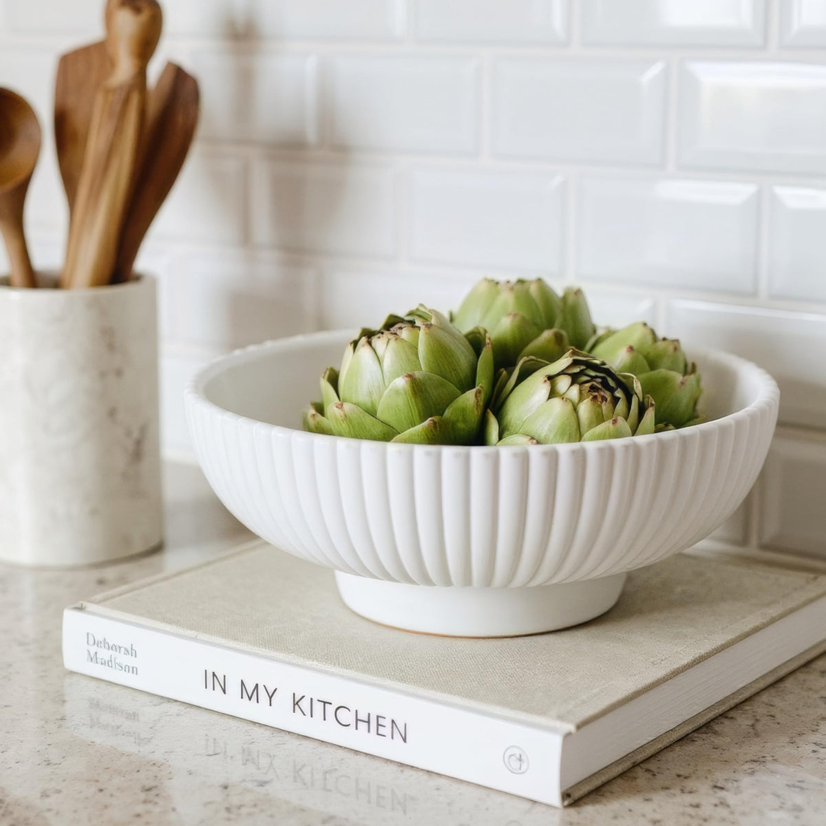 KIBAGA decorative concrete fruit bowl on a modern kitchen counter, highlighting contemporary style and function.