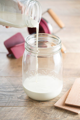 Kilner butter churner jar filled with cream showing small batch capacity.