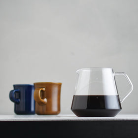 Graduated glass with measurements to track coffee output during brewing