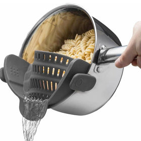 Kitchen Gizmo Snap N' Strain attached to a pot for hands-free draining while cooking