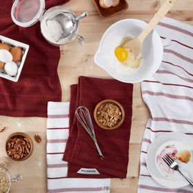 KitchenAid Albany striped towel on a rack, durable cotton-polyester blend.