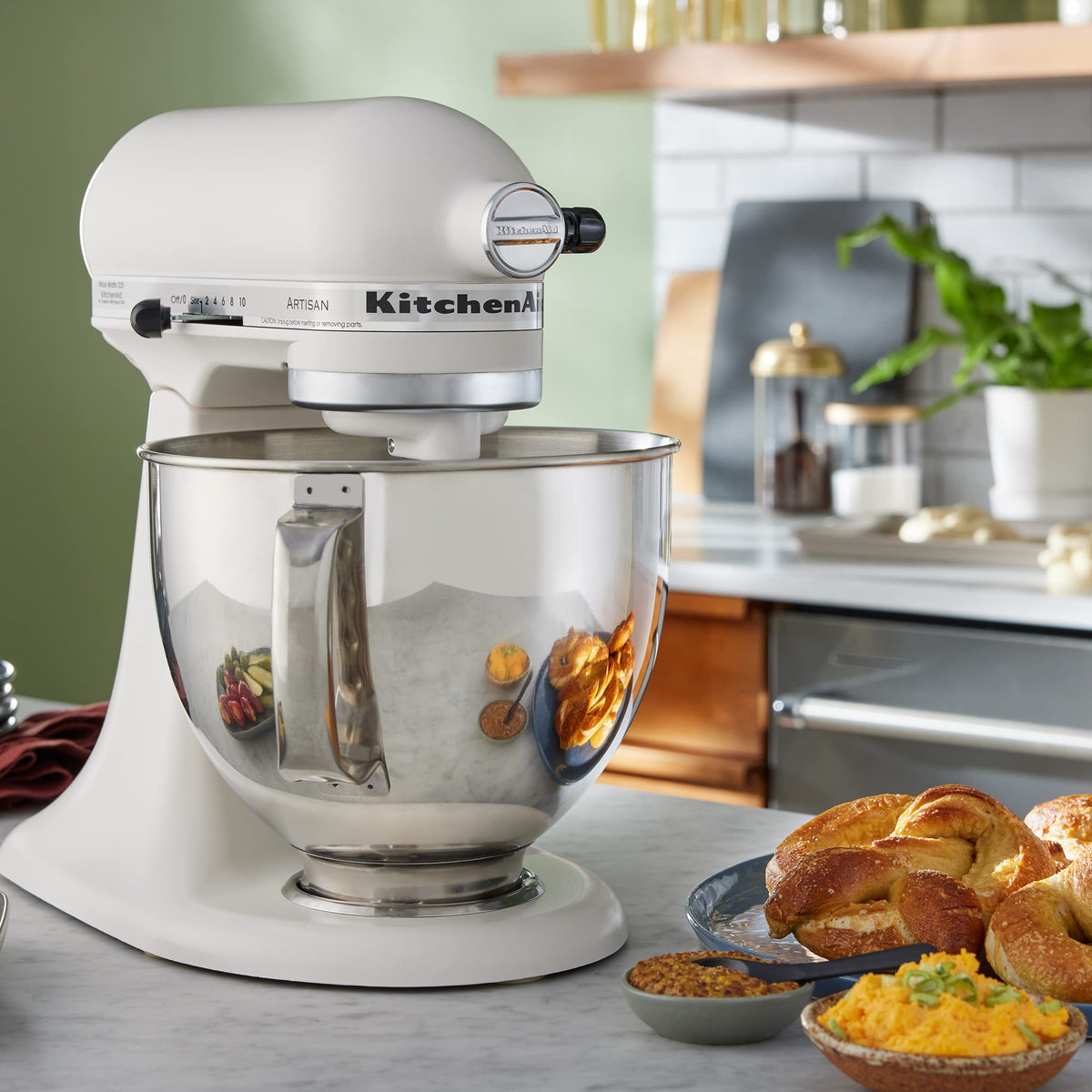 KitchenAid Artisan 5-Quart Tilt-Head Mixer with attachments enhances versatility.