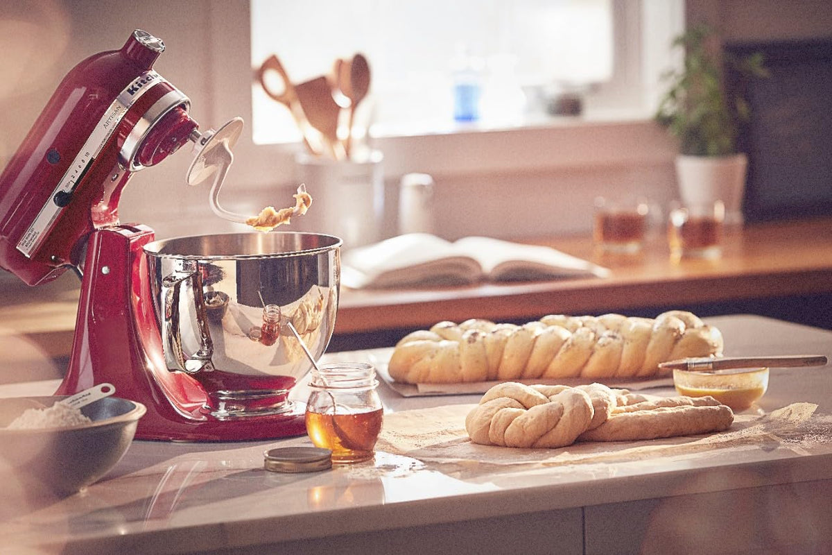 Empire Red KitchenAid mixer on countertop highlighting durable metal design.