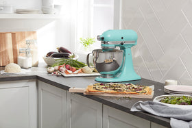 KitchenAid Aqua Sky mixer shown in a modern kitchen setup.