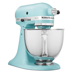 Pouring shield attached to KitchenAid Artisan mixer for mess-free ingredient addition.