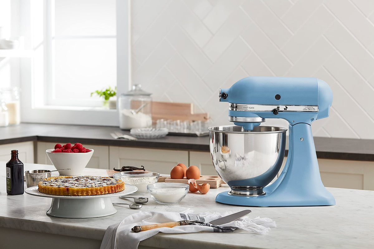 KitchenAid Artisan Tilt-Head Mixer in blue velvet highlighting hub-powered attachments option.