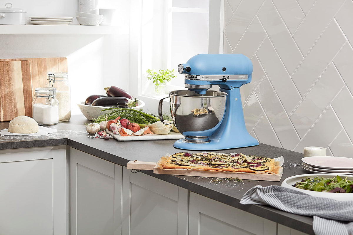 KitchenAid Artisan Tilt-Head Mixer with pouring shield aids clean ingredient addition.