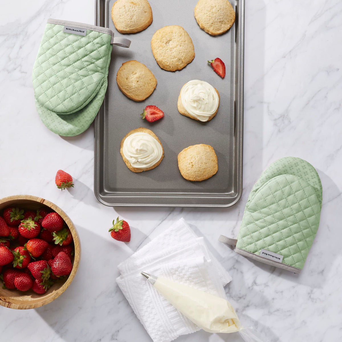 Pistachio KitchenAid Asteroid mini mitts in use with hot pot