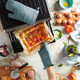 KitchenAid Asteroid oven mitts with hanging loop for easy storage in modern kitchens.