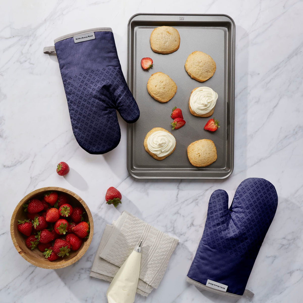 Textured heart-shaped silicone grips on KitchenAid mitts for a secure hold