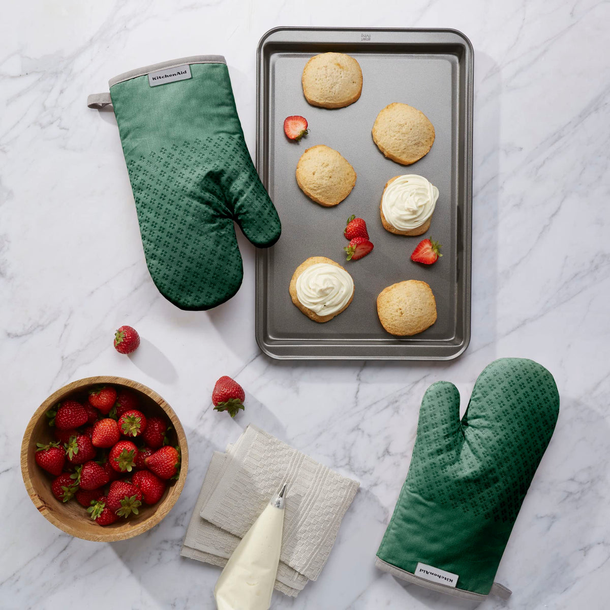 KitchenAid Asteroid oven mitts show textured silicone grips for secure cooking tasks.