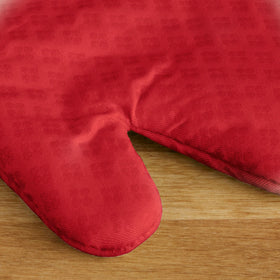 KitchenAid Asteroid oven mitts fire red exterior made of cotton fabric for insulation.