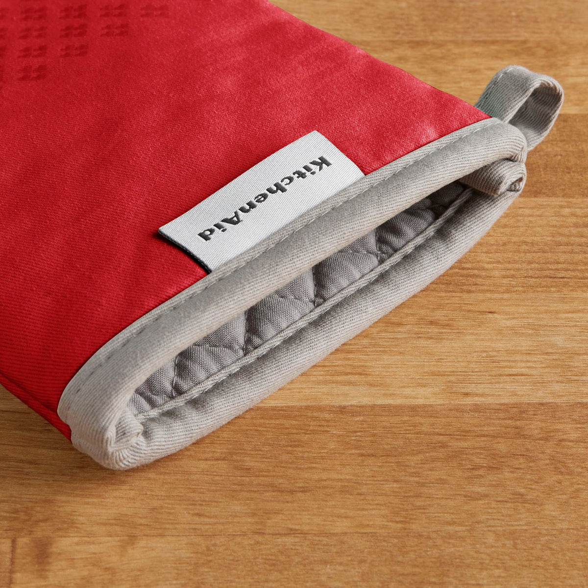 KitchenAid Asteroid mitts fire red show silicone grips for better control with hot cookware.