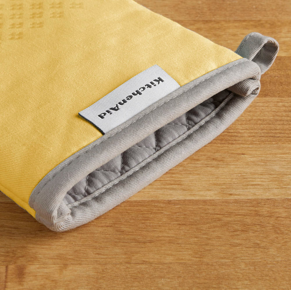 KitchenAid Asteroid oven mitts showing hanging loop for easy storage