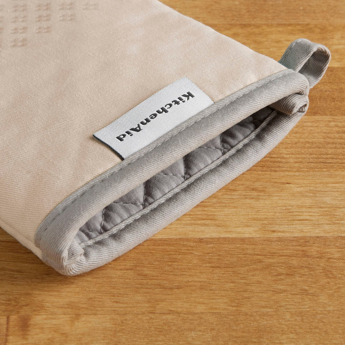 Hanging loop visible on KitchenAid Asteroid Mitts for easy storage.