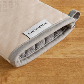 Hanging loop visible on KitchenAid Asteroid Mitts for easy storage.