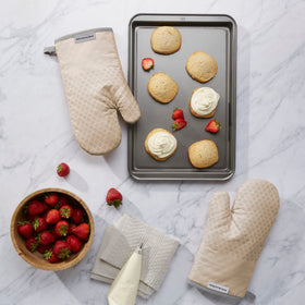Close-up of KitchenAid Asteroid Mitts silicone grips for secure handling.