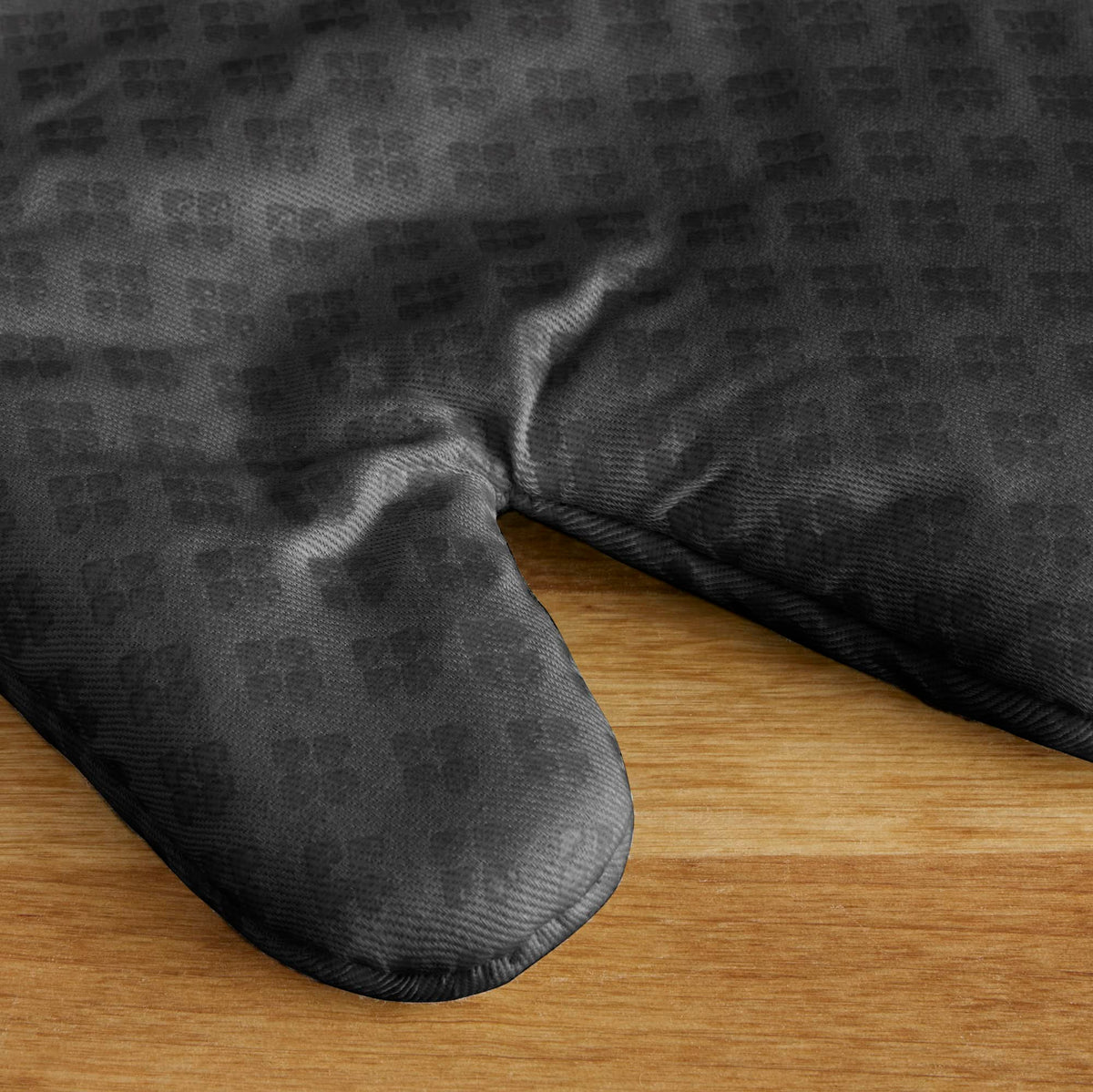 KitchenAid Asteroid oven mitts showing the hanging loop for easy storage.