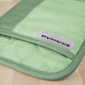 Easy-care KitchenAid Beacon pot holder being machine washed